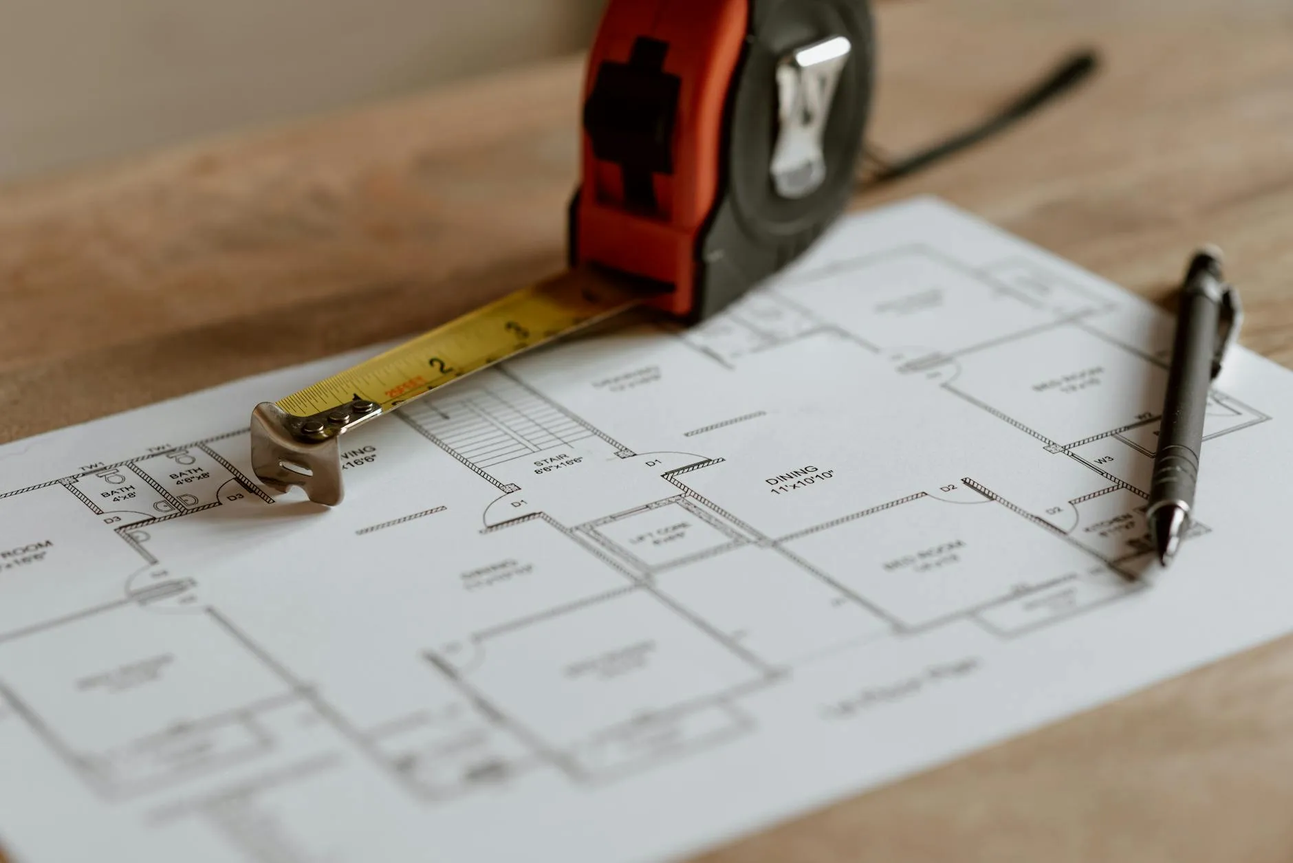 Floor plan with a tape measure and pen