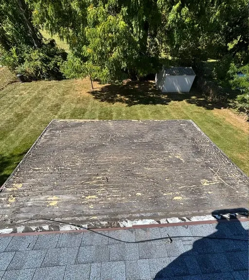 Worn low-slope roof section before repair